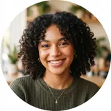 Young woman with curly dark hair in an olive knit top